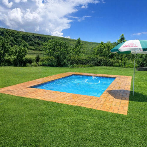 Outdoor Swimming Pool at Plain Champagne Guest Farm Outdoor swimming pool at Plain Champagne Guest Farm set on a lawn with mountain views and open countryside